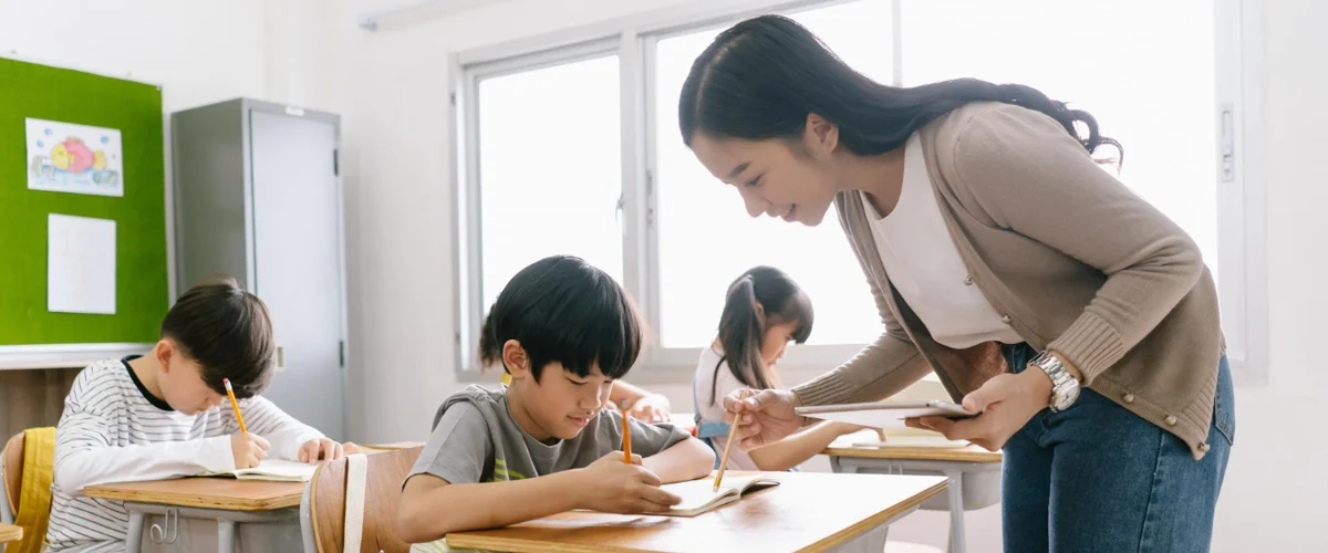 Teacher guiding her student during assignment period.