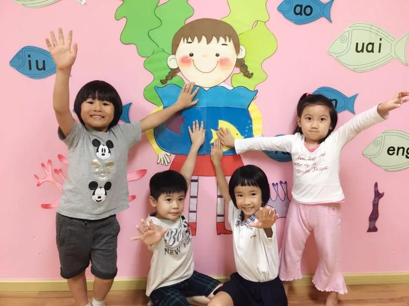 Beijing Language School students learning Chinese with Hanyu Pinyin, character recognition, and writing practice in a classroom setting.