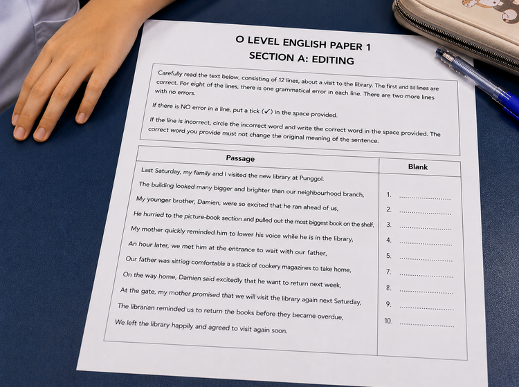 O Level Editing sample paper on a classroom table with answer blanks.