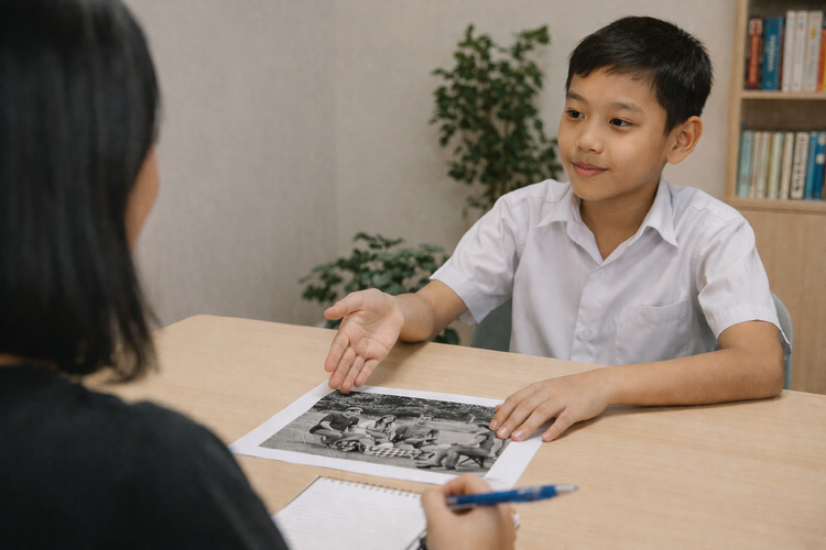 Male primary school student discussing a photograph for stimulus-based conversation.