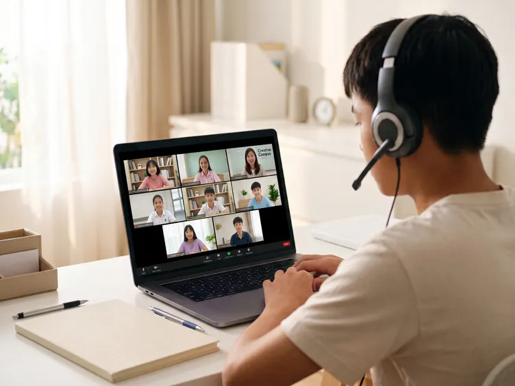 Student joining an online English class on Zoom with his teacher and classmates.