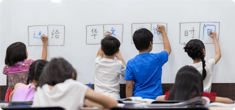 Tien Hsia Language School teacher guiding students in Chinese grammar and writing exercises to build strong language skills.